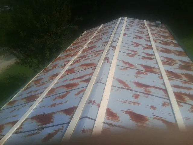 Rusted metal roof panels with new wood purlins before replacement — Storm Damage Roof Repair in Cayuta by Roofing Brothers