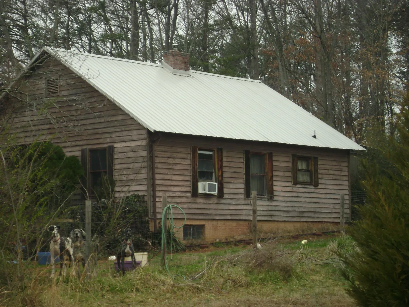 White metal roof on an old wood sided farmhouse, from a Metal Roof Installation job in Cayuta
